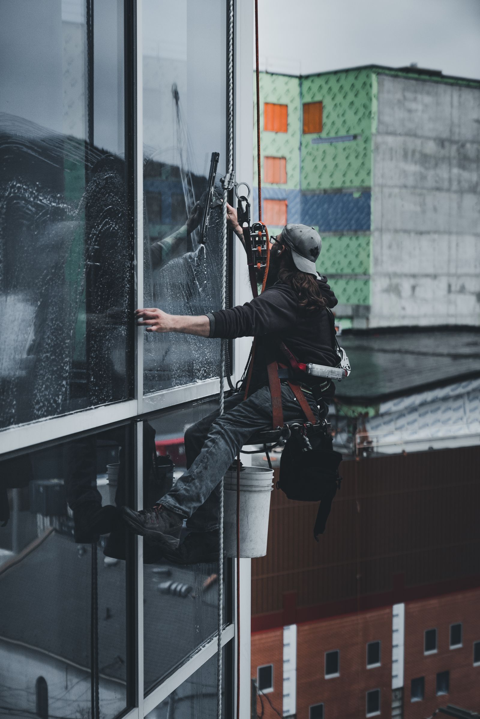 Technician cleaning a high-rise glass tower