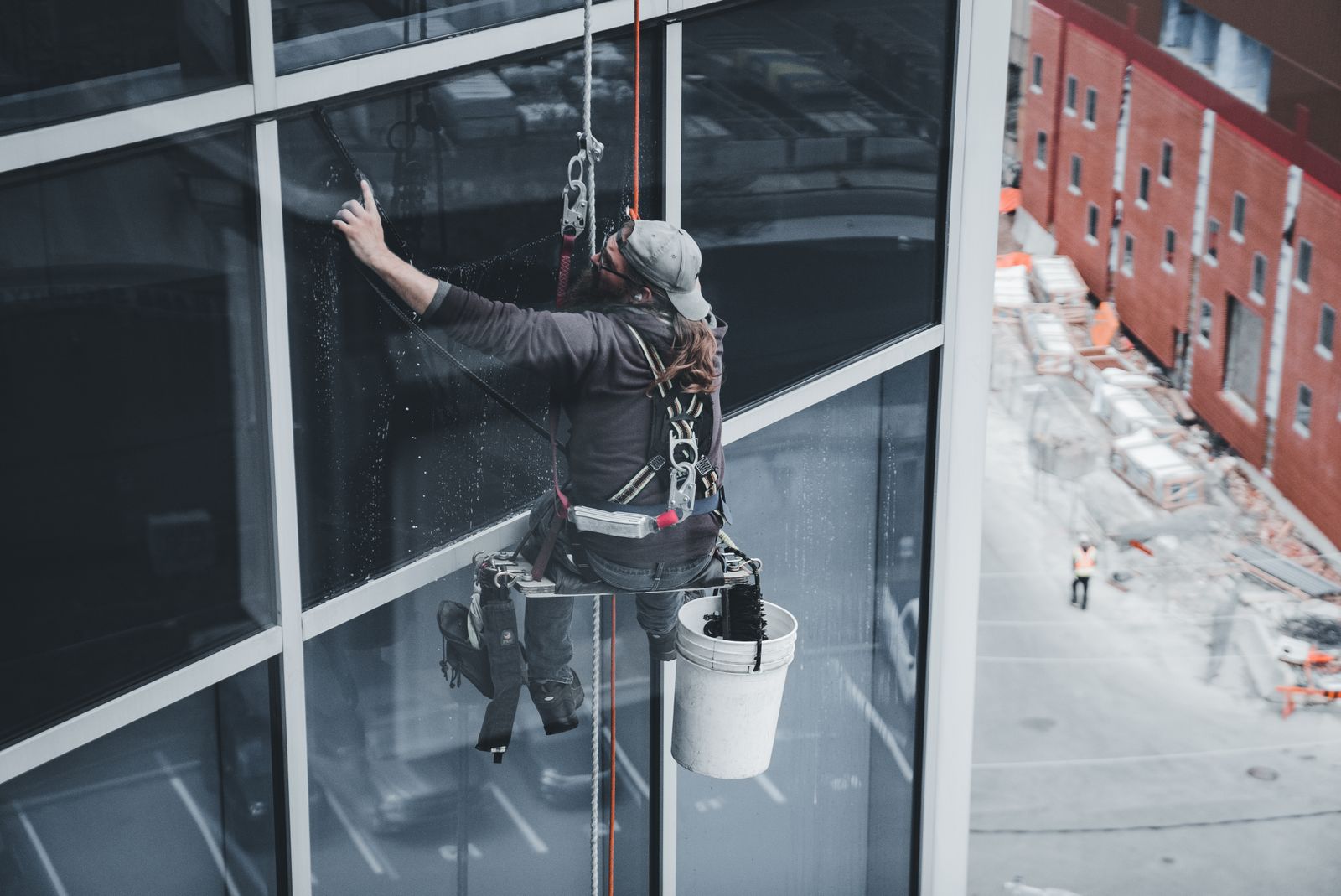 Rope-access window cleaner at work